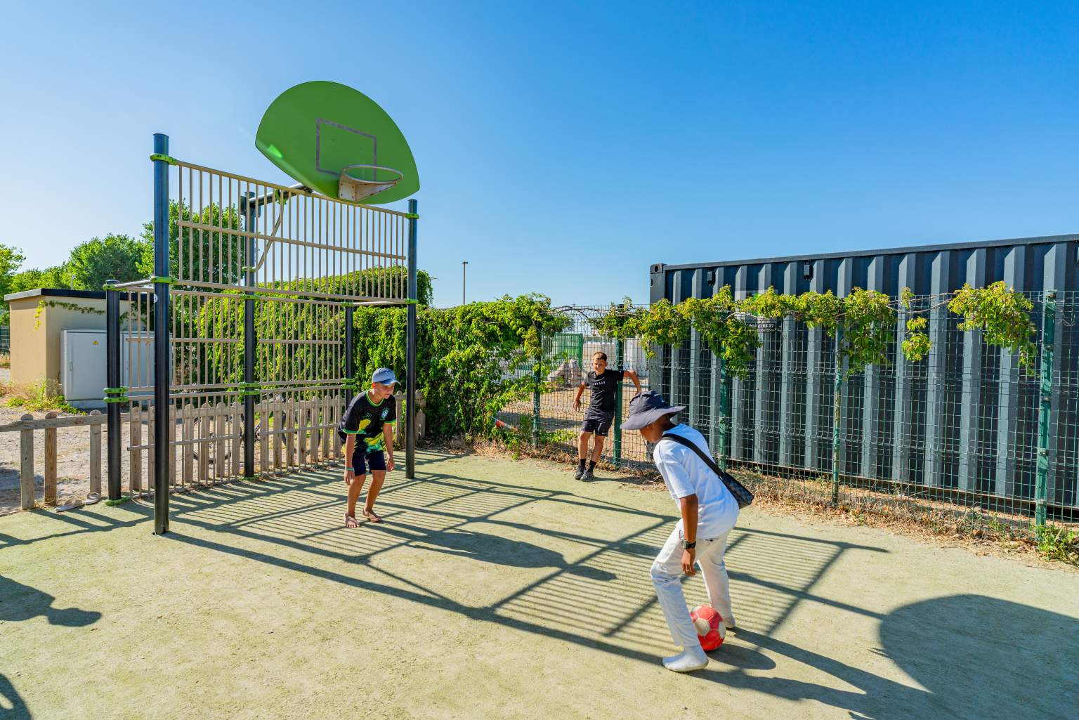 Game of football on the multi sports court at Novela Port La Nouvelle campsite, Languedoc