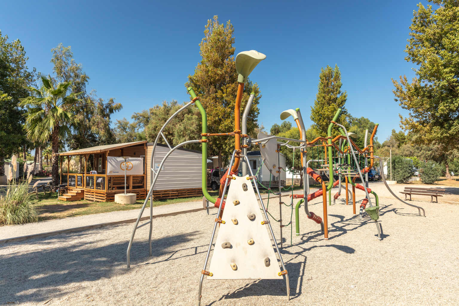 Play area with climbing frame near the holiday homes at Plage et le Bord de Mer campsite, Languedoc