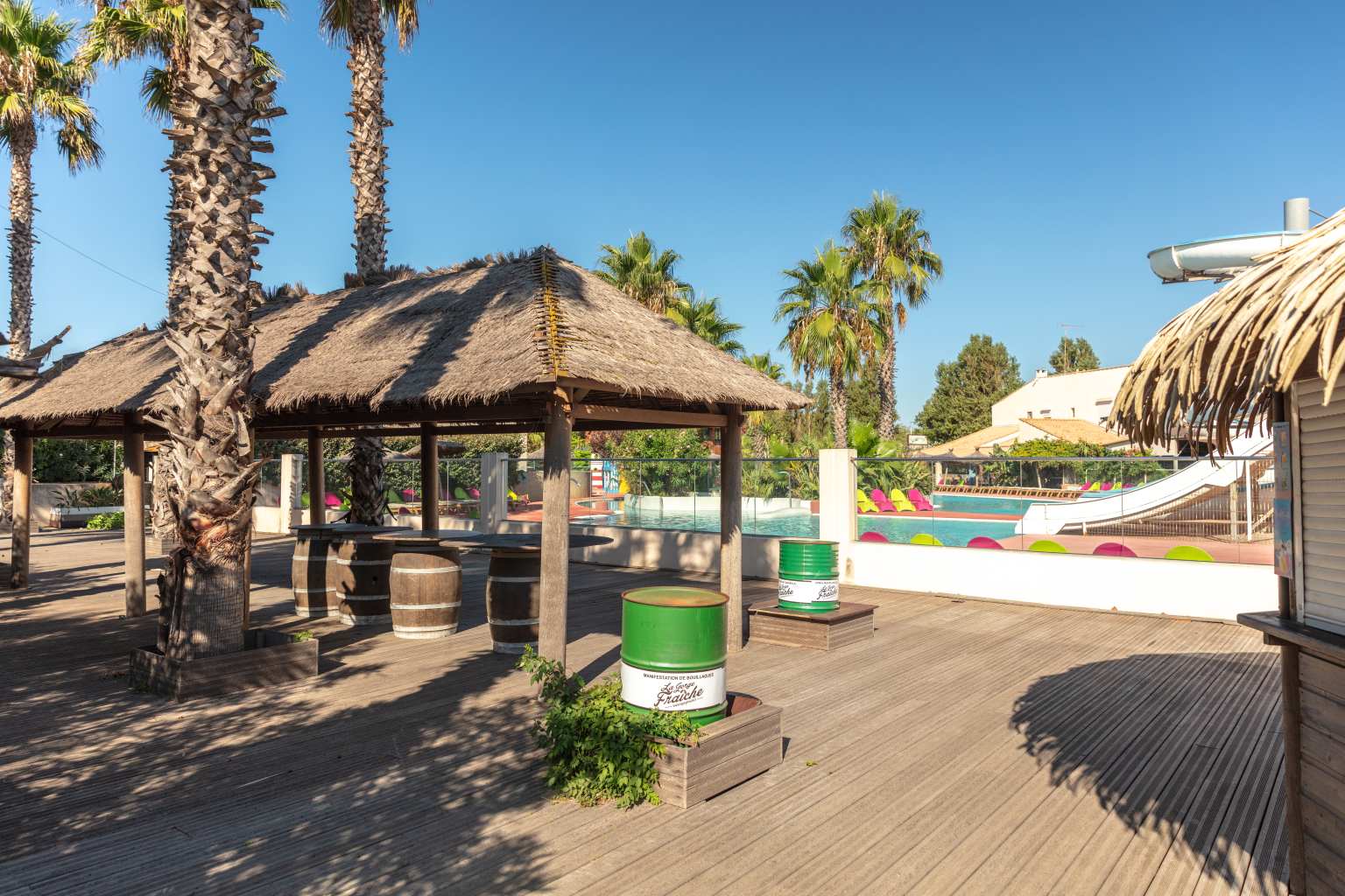 Shaded bar terrace next to the pool at Plage et le Bord de Mer campsite, Languedoc