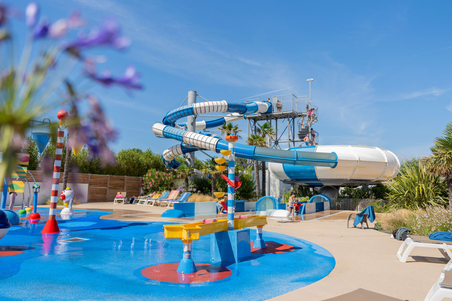 Pool area with waterslides at Camping Les Places Dorées in the Vendée