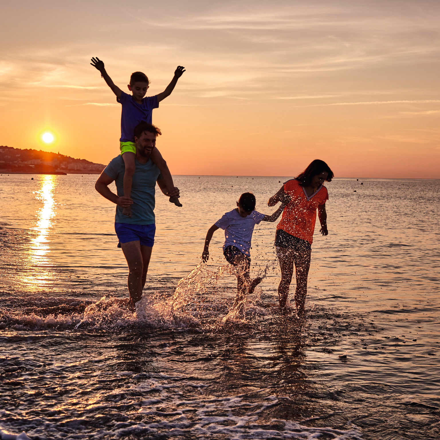 Family at the beach at sunset