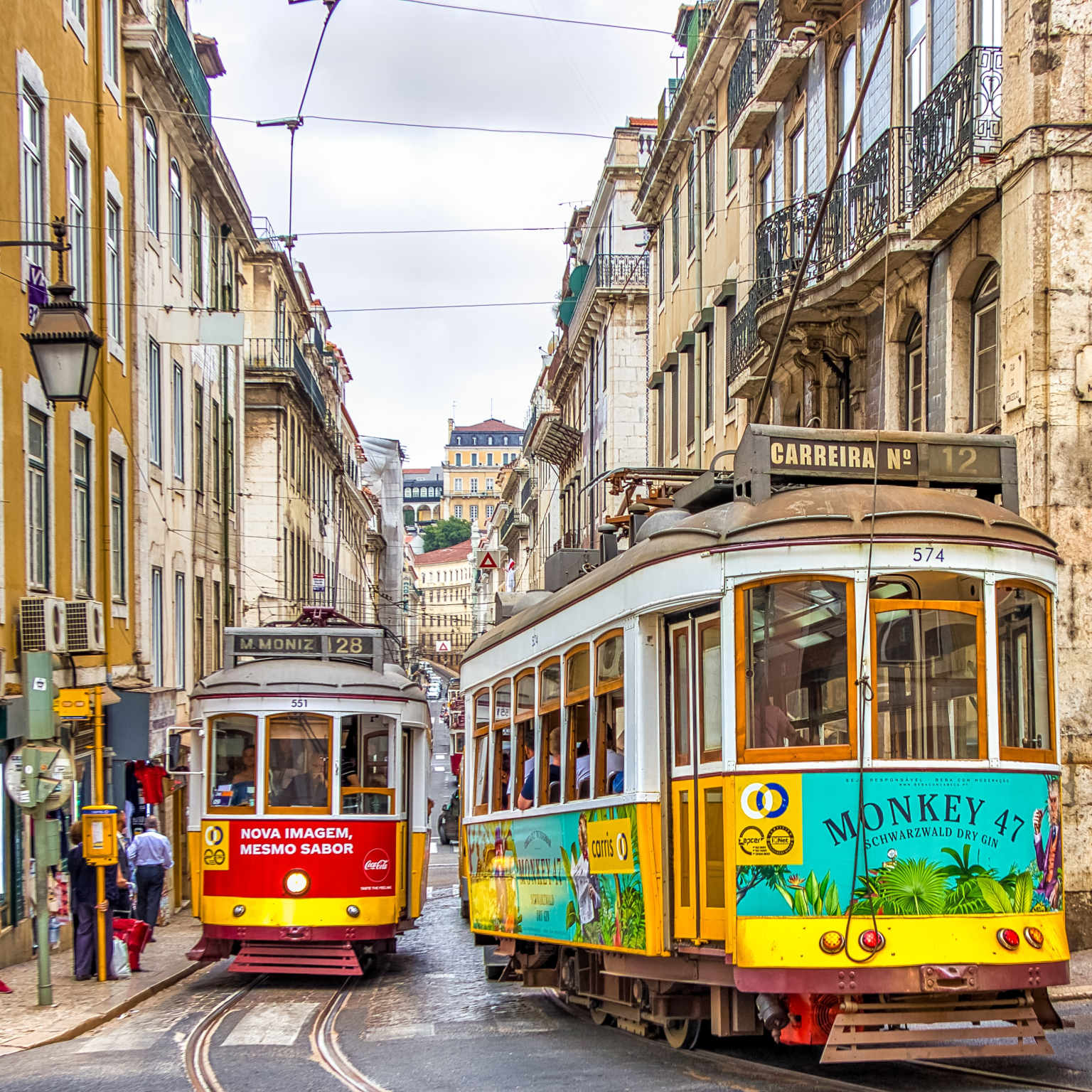 Two colorful trams in Lisbon, Portugal