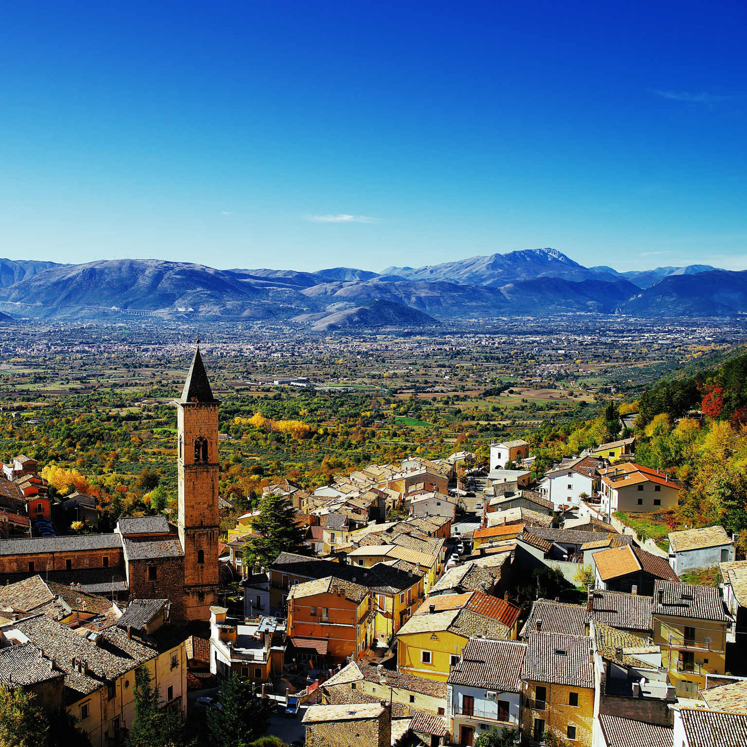 distant view of city contrasted with countryside, Abruzzo, Italy