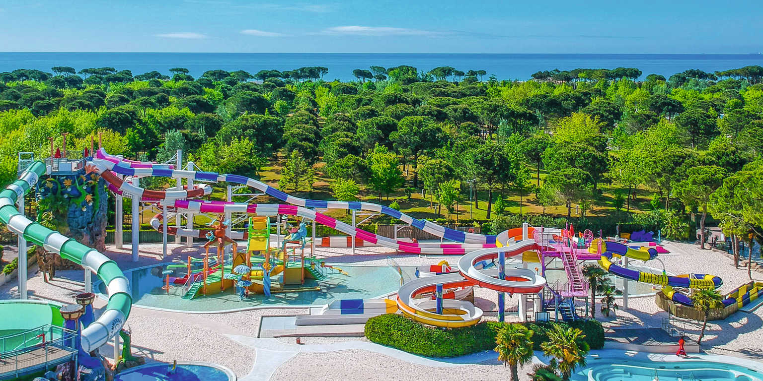Waterslides and splash playgrounds at an outdoor pool, Union Lido, Italy