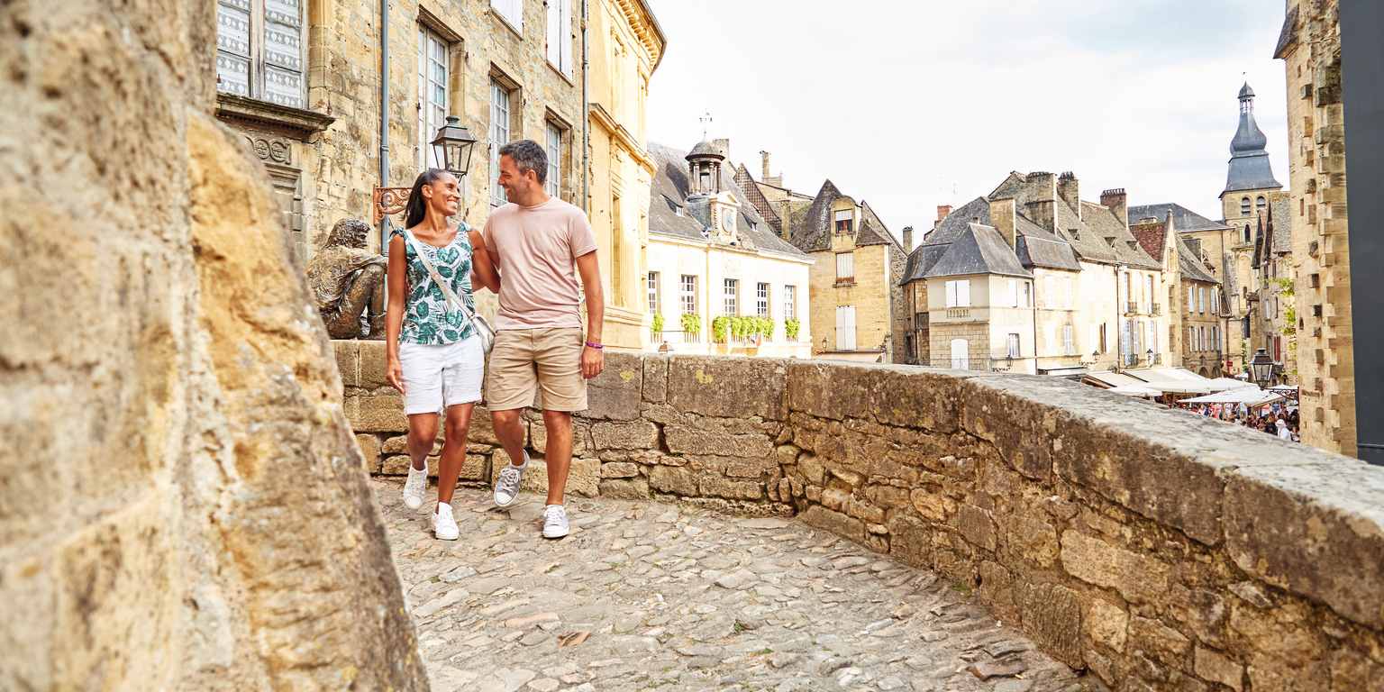 Couple walking in Sarlat town, Dordogne, France