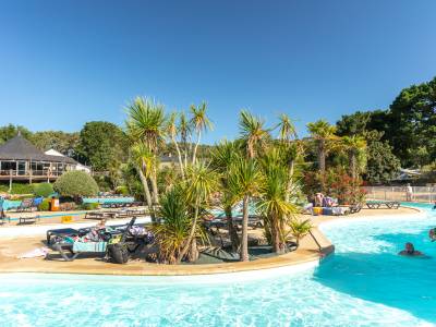swimming in the lazy river by the palm trees at la grande metairie, campsite, south brittany