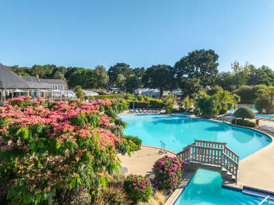 bridge over the family pool, next to bank of pink rhodendrons, at la grande metairie, campsite, south brittany