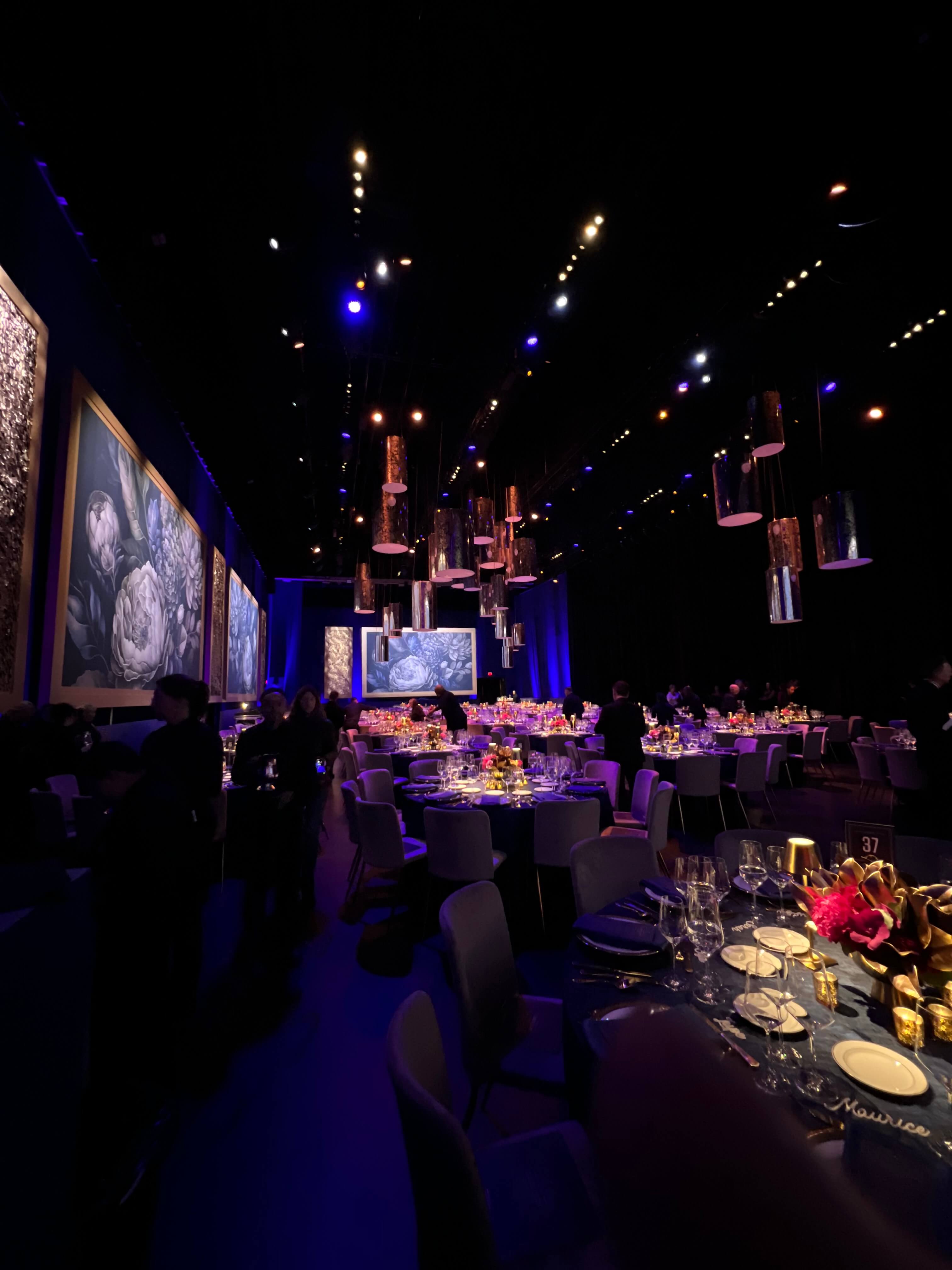 Segerstrom Candlelight Gala — dinner tables beneath the floral art installation