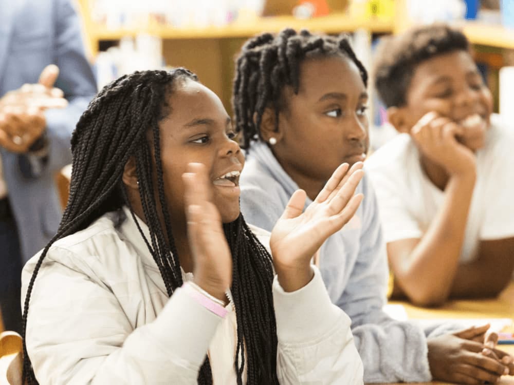 Three students engaging in a classroom group activity.