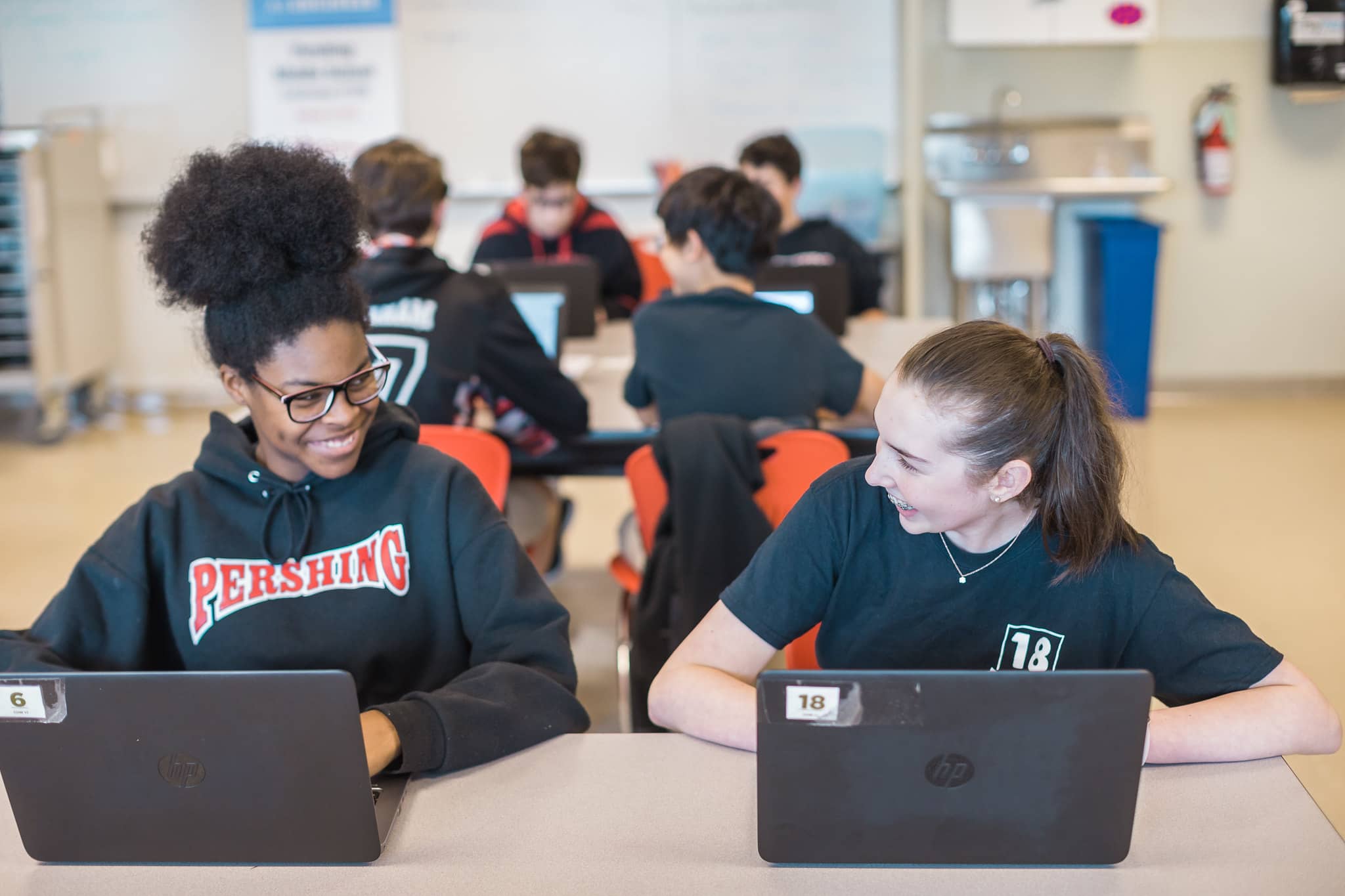 Two high school students on classroom computers