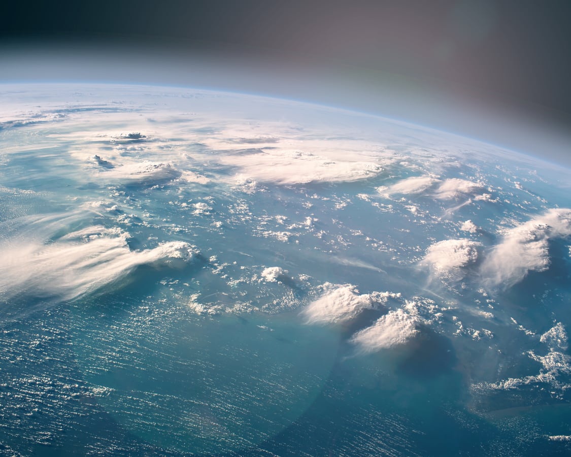 Earth viewed from space with blue oceans and white clouds in focus