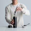 Ever Vessel Multi Black Sand vacuum insulated water bottle with tea infuser being inserted