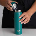 Female taking lid off an Ever Vessel Mini Teal green water bottle