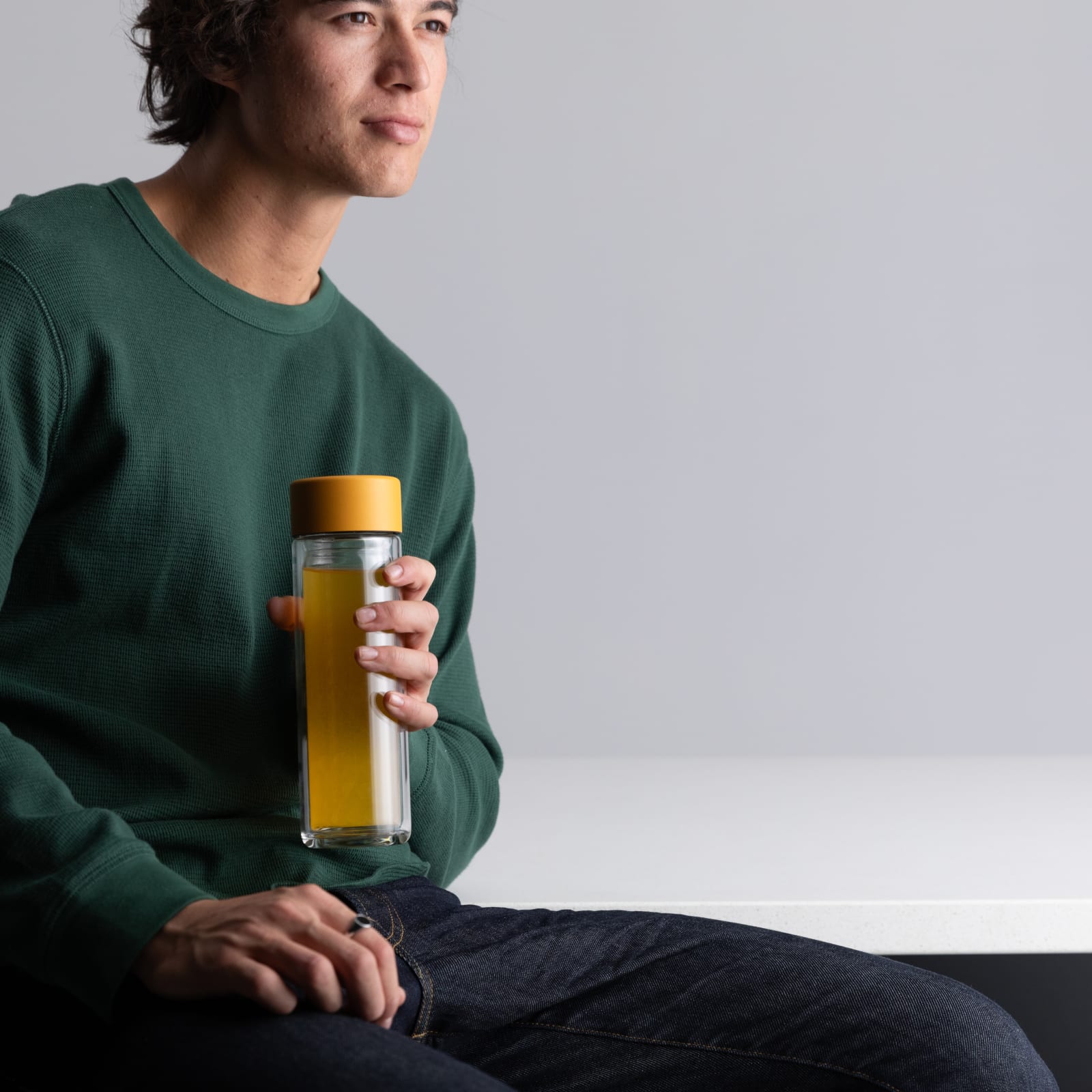 Male holding an Ever Vessel Glass Multi tea flask with a yellow lid and mango bubble tea inside