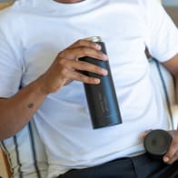 Male holding an Ever Vessel Multi Blacksand water bottle engraved with his name