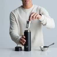 Ever Vessel Multi Black Sand vacuum insulated water bottle with tea infuser being inserted