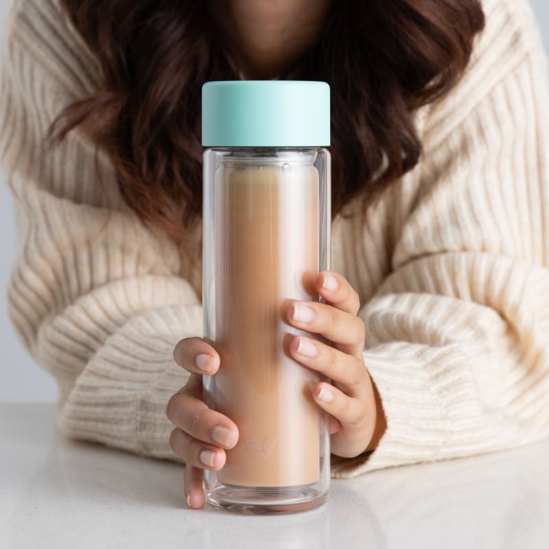 Lady holding Ever Vessel Glass Multi Mint bottle containing Milk Tea