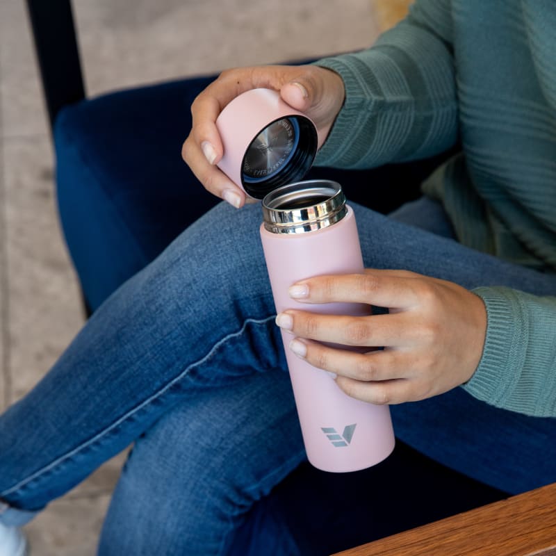 Female holding Ever Vessel Mini Rose water bottle with lid off