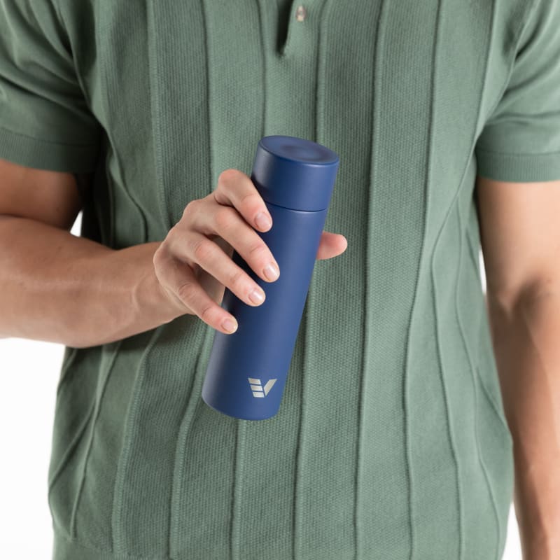 Male holding an Ever Vessel Mini Blue water bottle