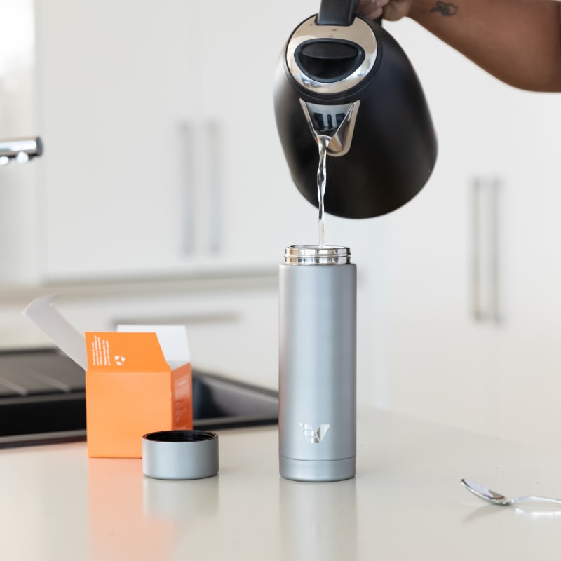 Man making a tea with an insulated Ever Vessel Multi Plain Stainless Steel Bottle with tea infuser