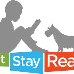 The prpfile of a small boy reading a book to a dog in grey with a green, blue and red logo with the words Sit Stay Read below.