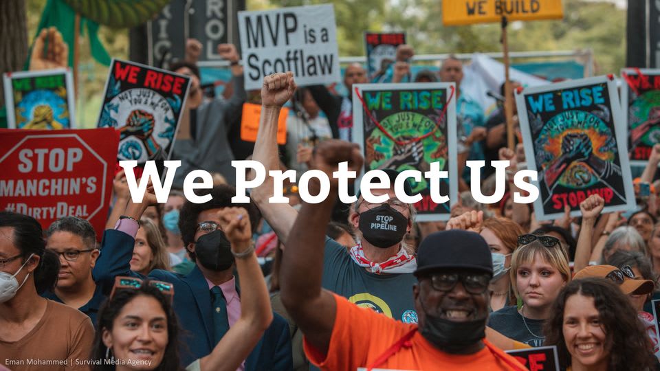 People holding banners and marching with fists raised.