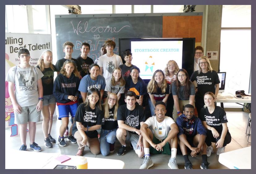 Group picture with young middle school students smiling at a training event where they learned about making stories and apps