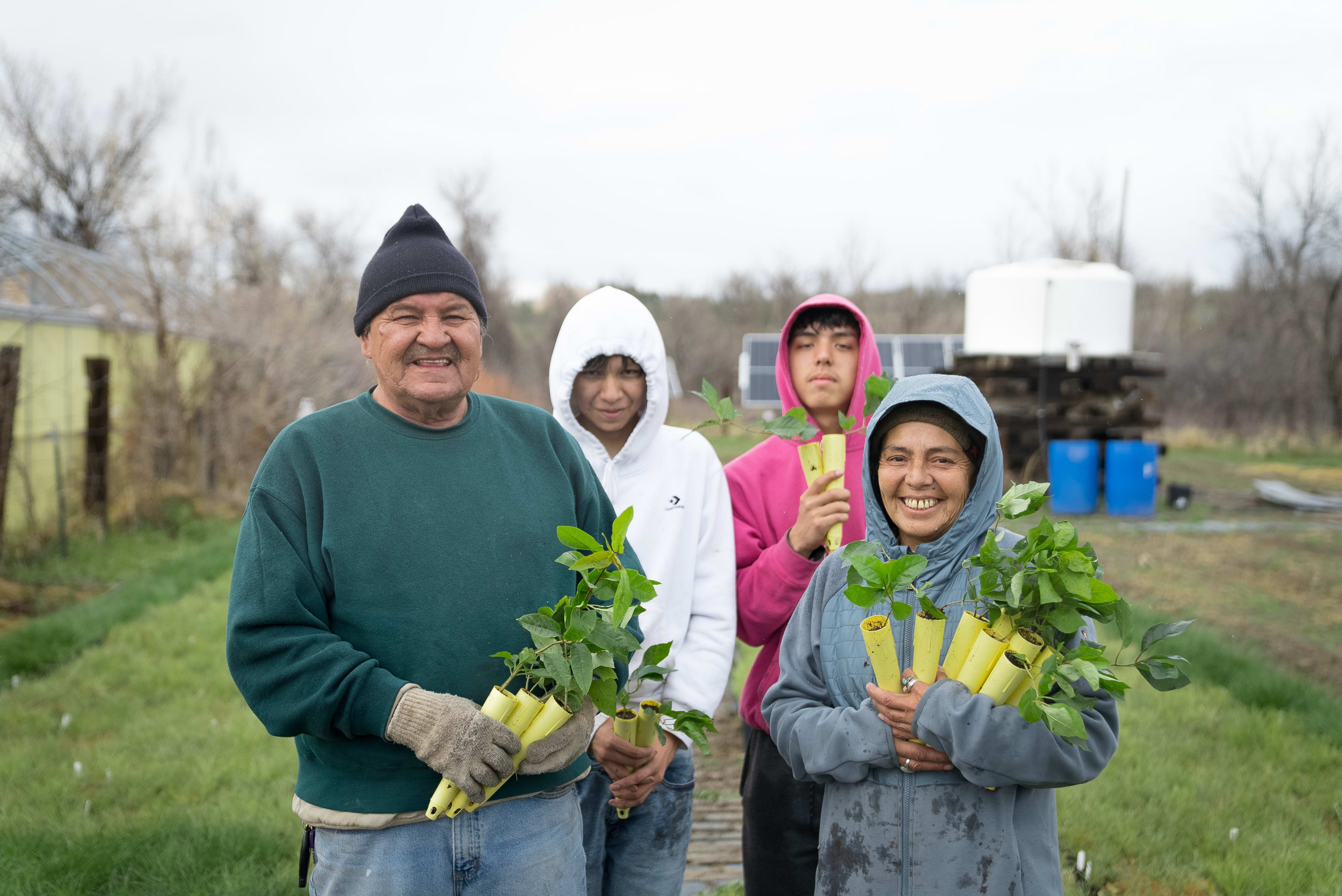 Chief Henry Red Cloud and his family holding tree seedlings to be planted in the Pine Ridge reservation
