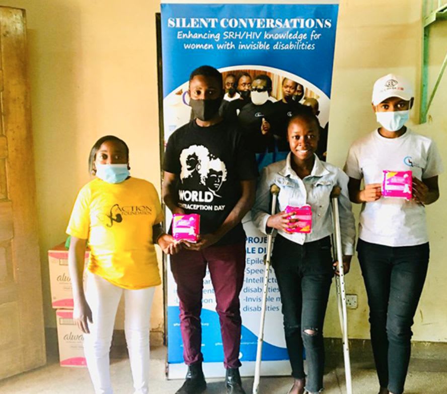 Girls with disability and a young man holding a sanitary pad