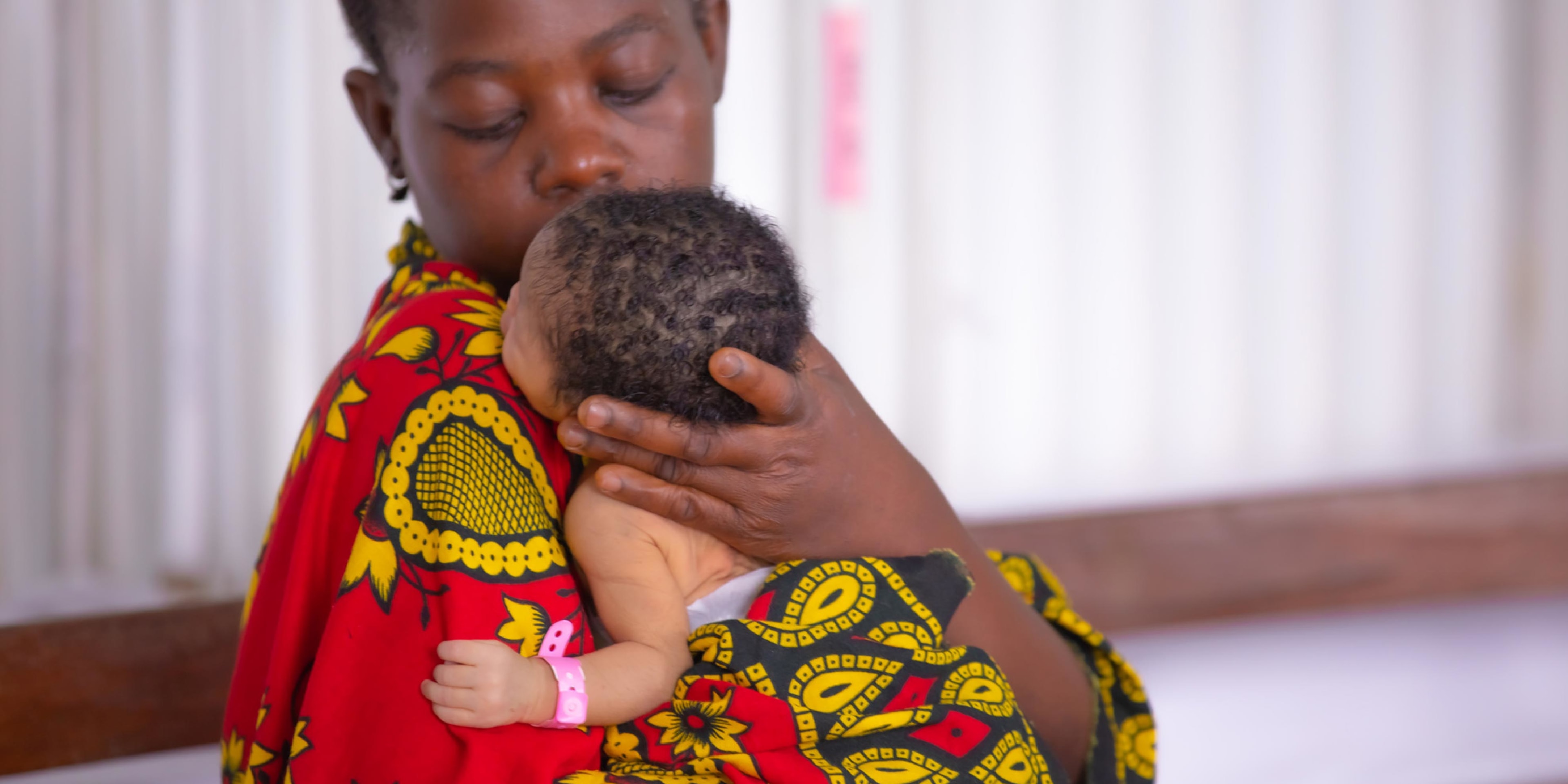 Mom holding her newborn baby in a hospital in Tanzania