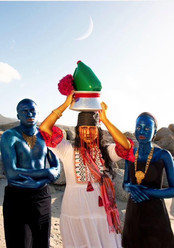 Artistic photograph of three people dressed in extravagant costuming and body paint looking into the camera. Image courtesy of Mika'il the Muezzin 