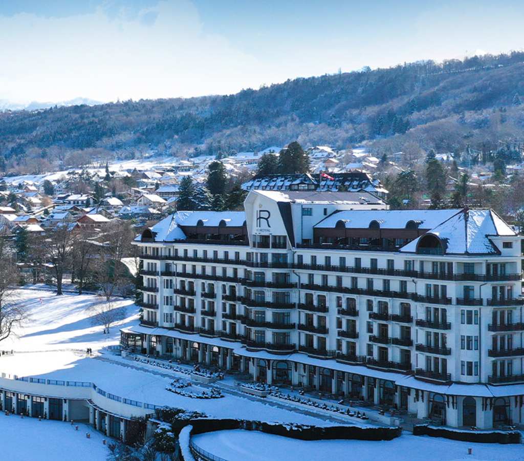 Hotel Royal Evian under the snow with the Alps in the background