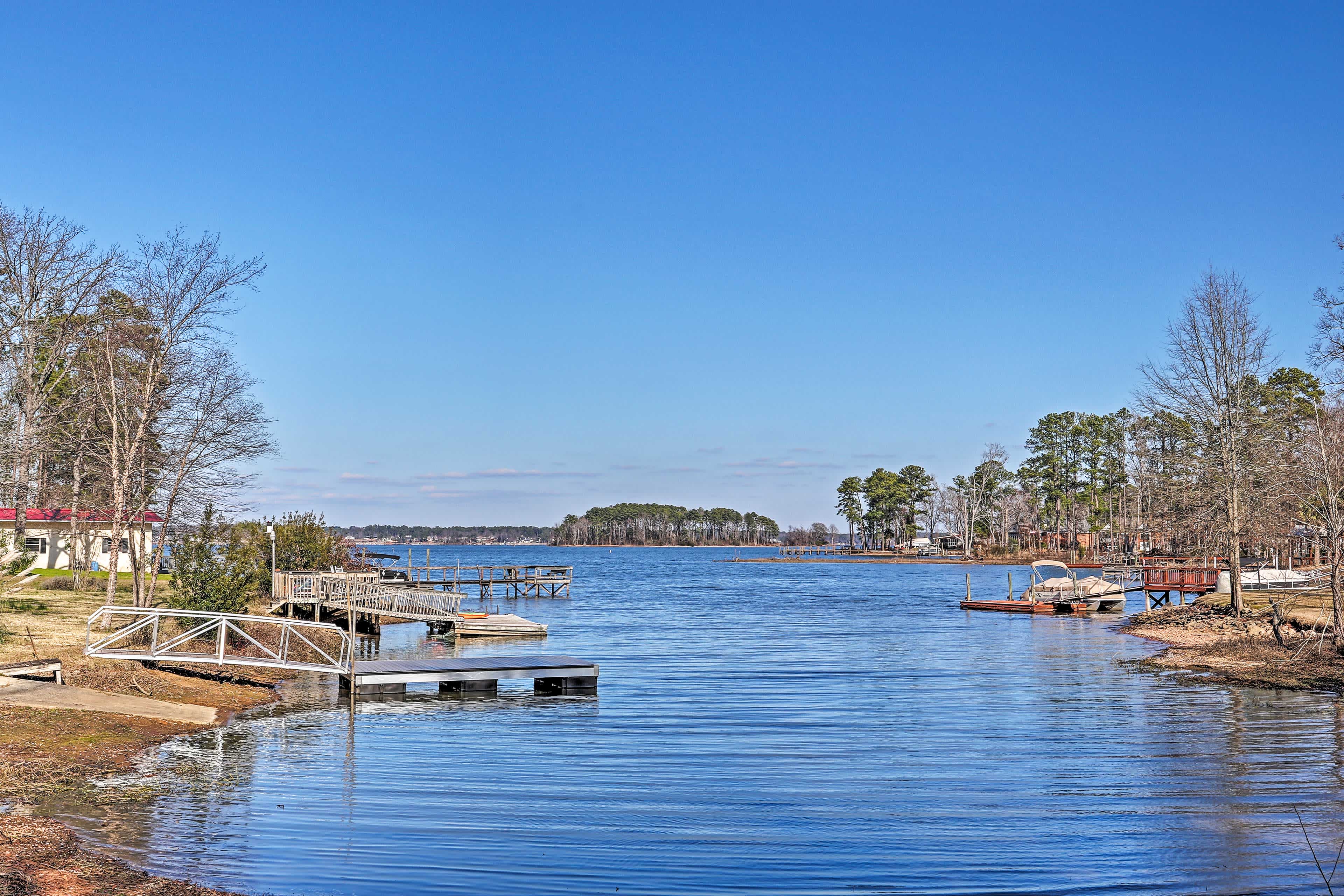 View of a lake with docks, boats, and blue skies overhead in Gilbert, AZ