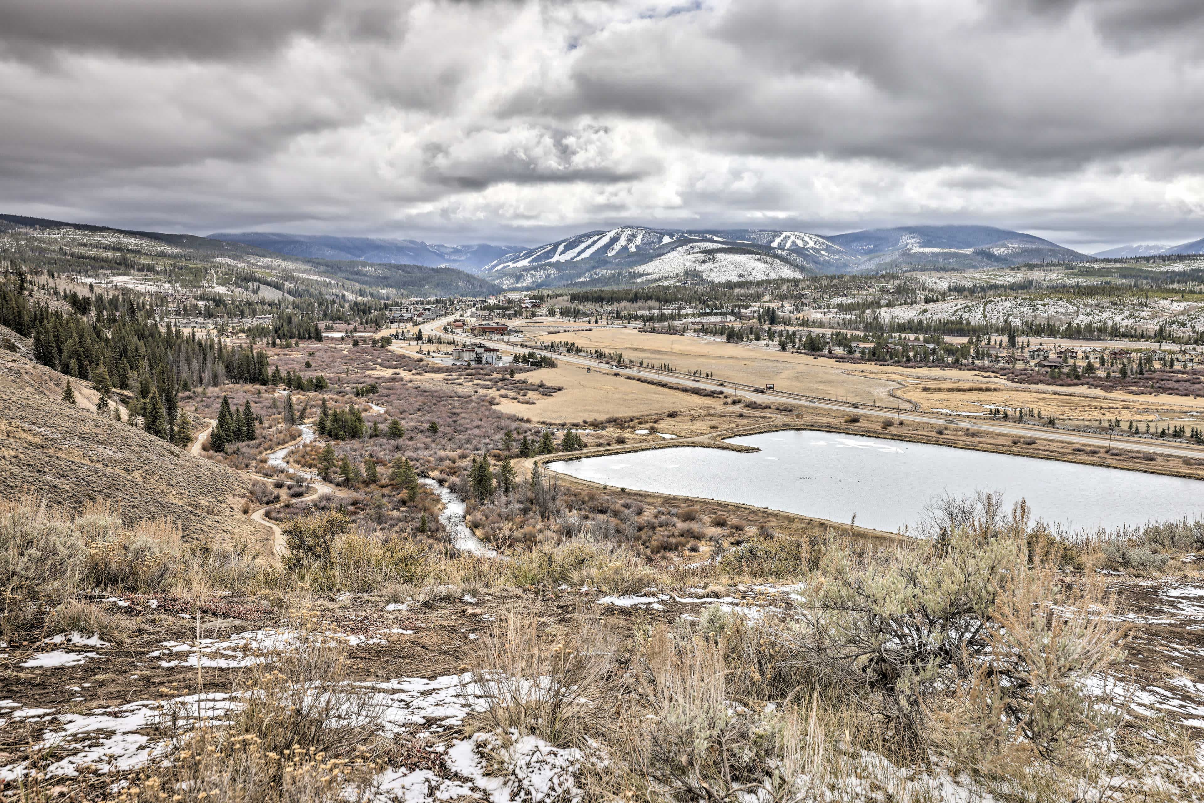 View of a frozen lake and a mountain view in the distance in Frasier, CO