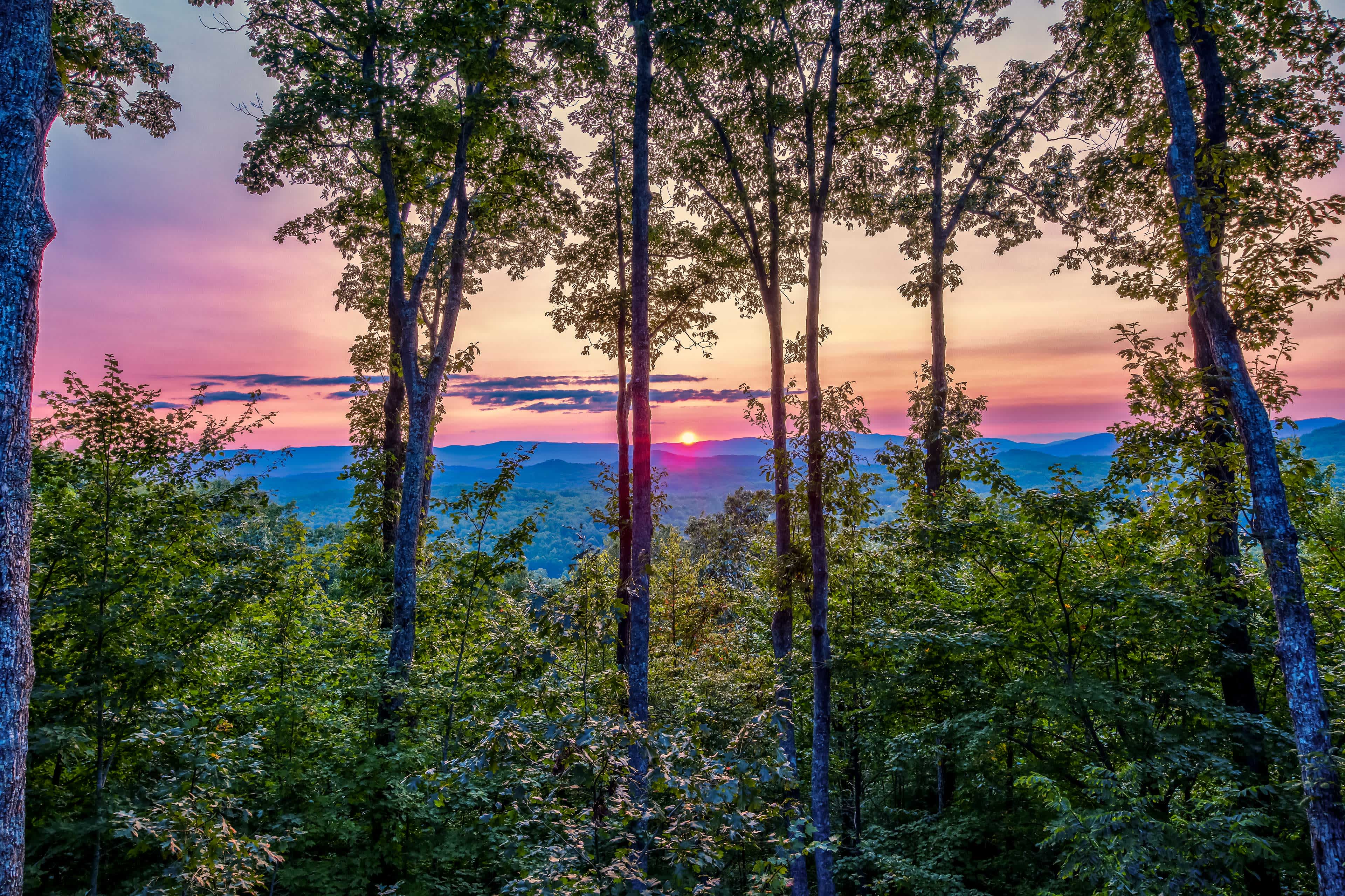 Landscape view of a sunset in Morganton, GA with distant mountains