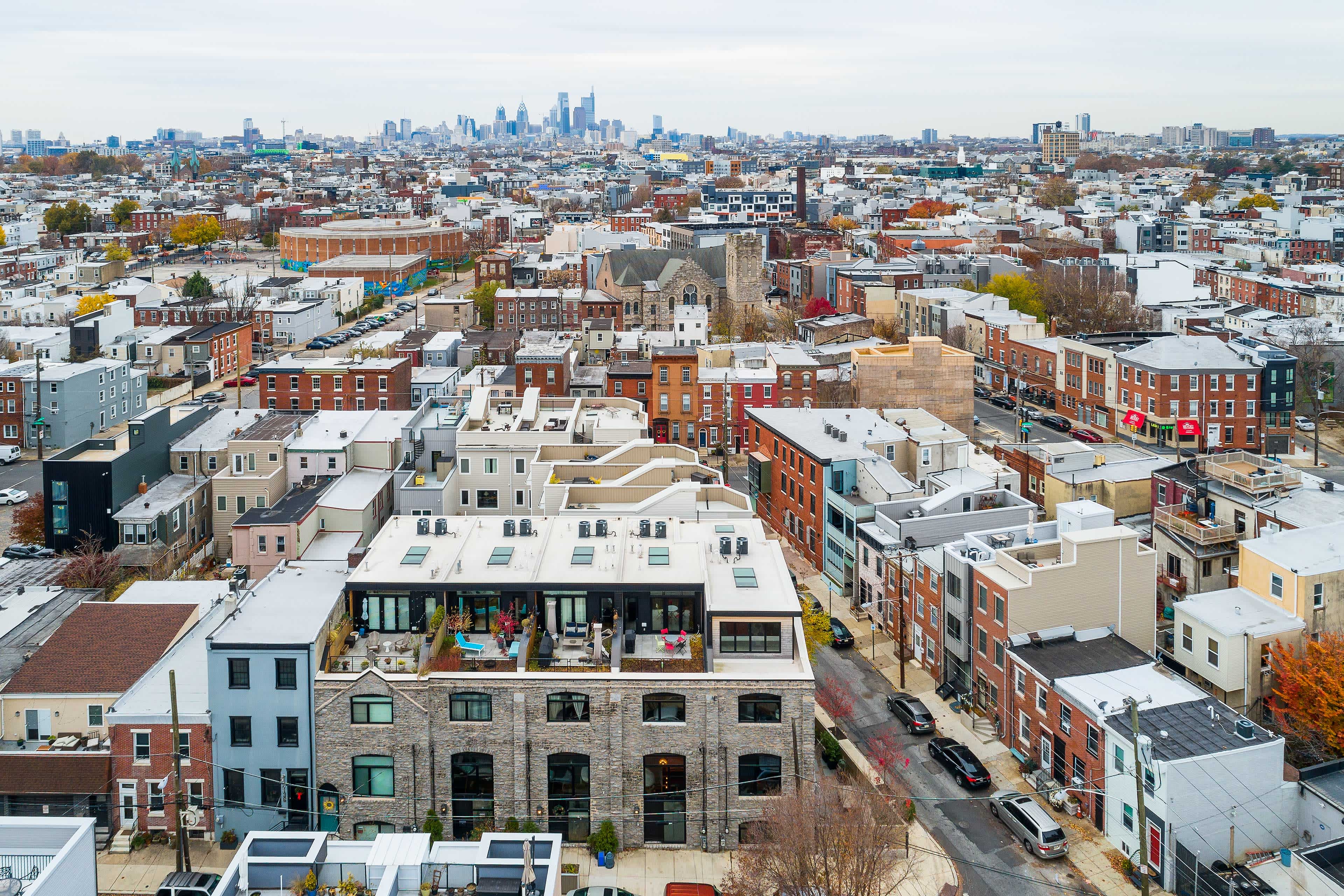 Aerial view of urban buildings with the Philadelphia, PA skyline in the background