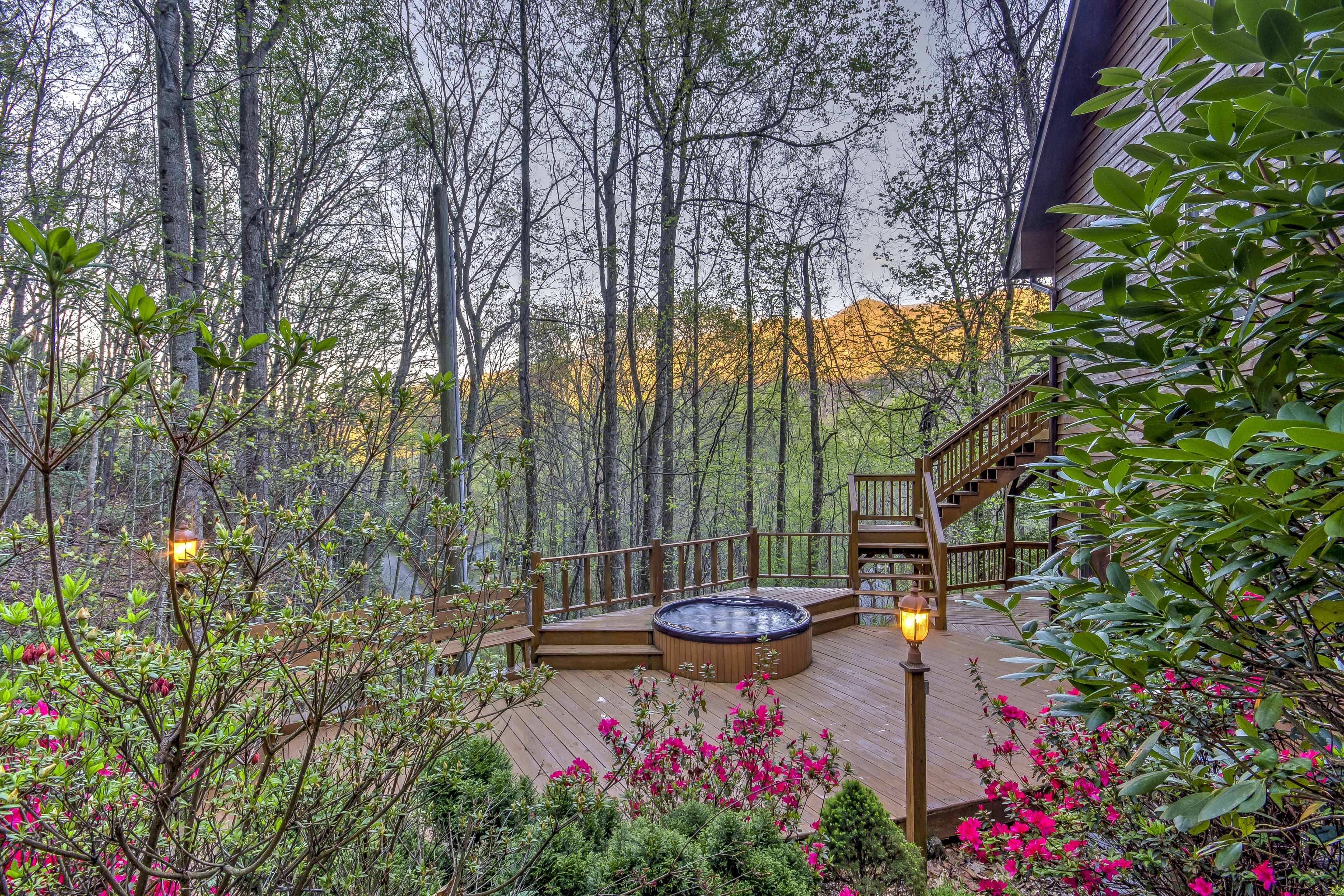 Private hot tub next to an in-ground pool on a sunny red brick patio