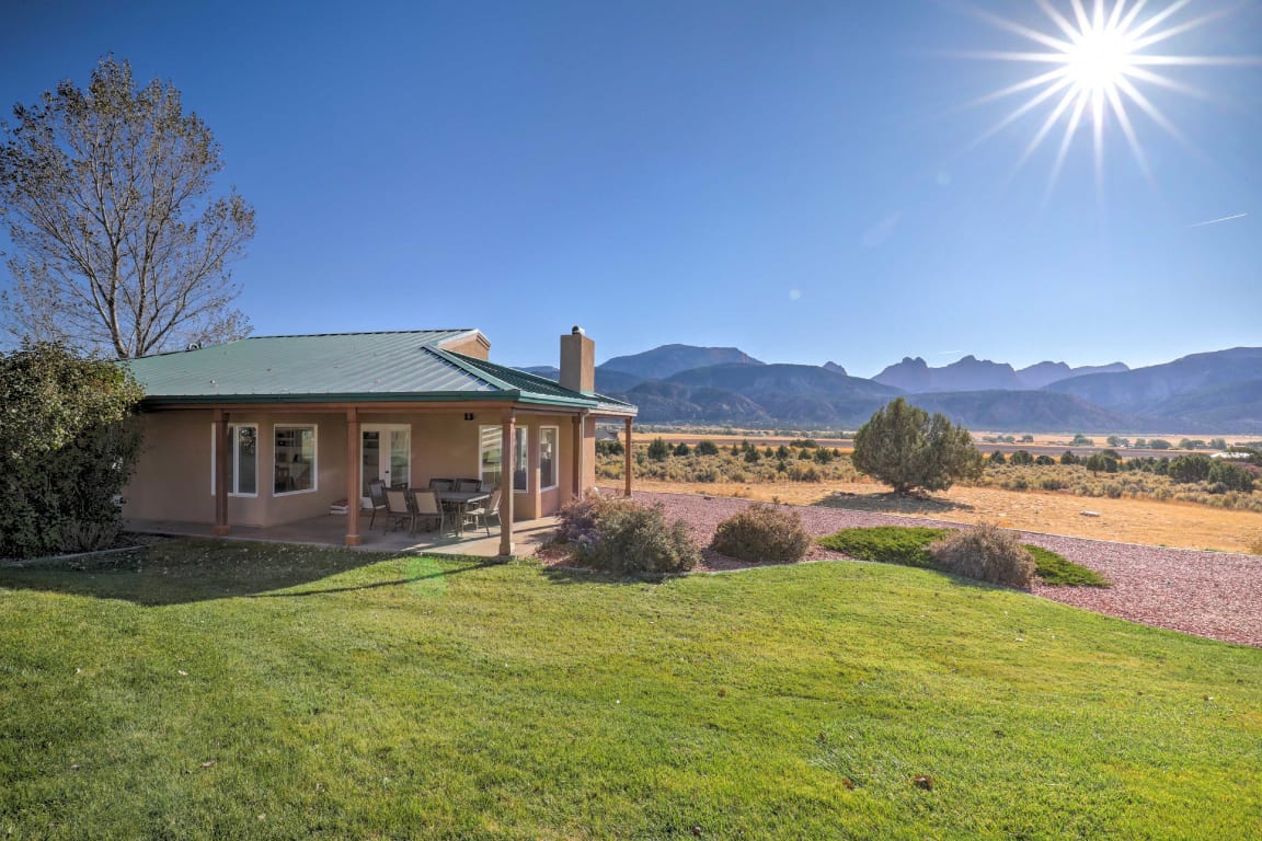 Vacation rental overlooking mountain range on a clear, sunny day