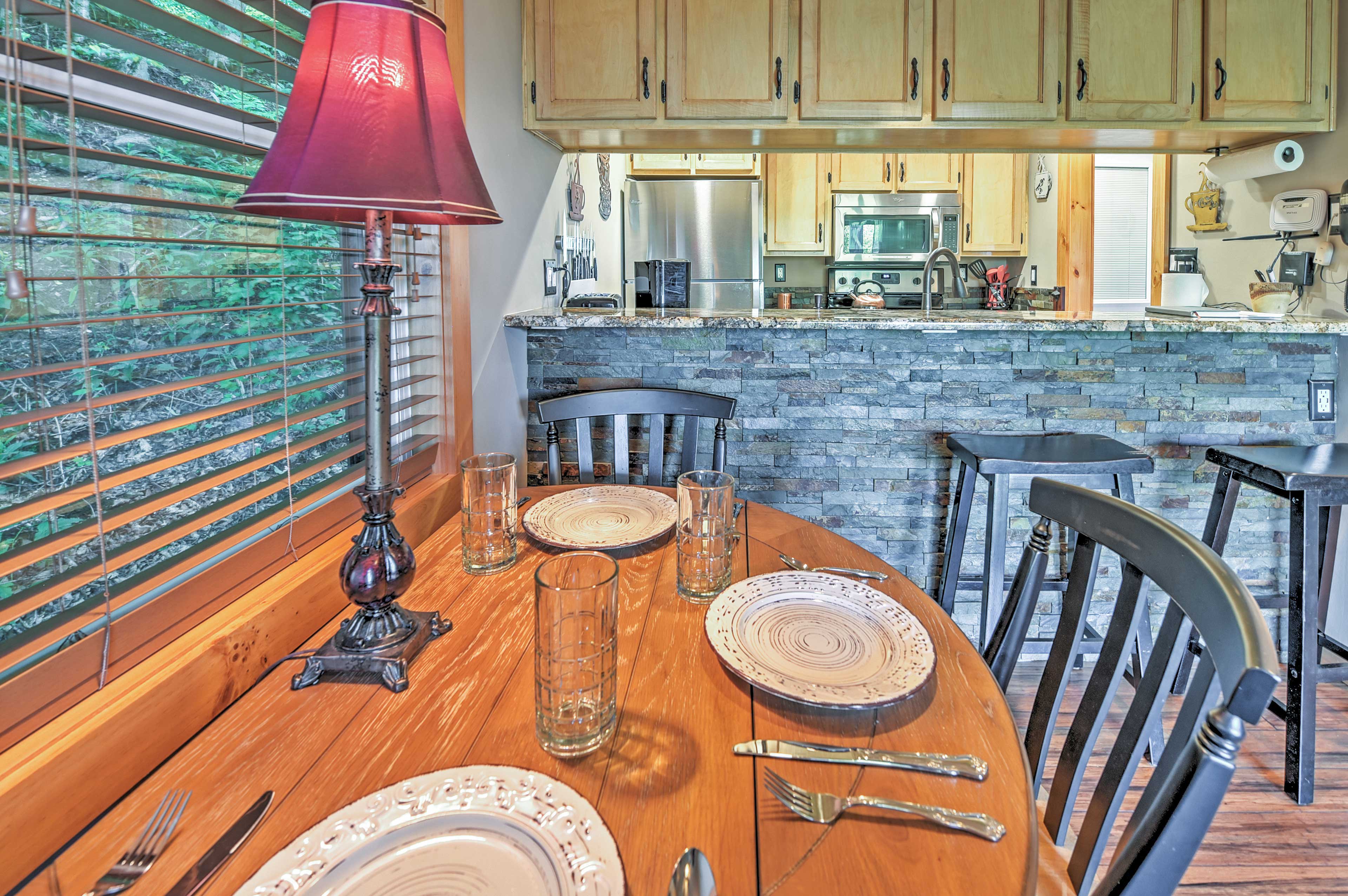 Set the dining table while the group chef finishes up dinner's final touches.