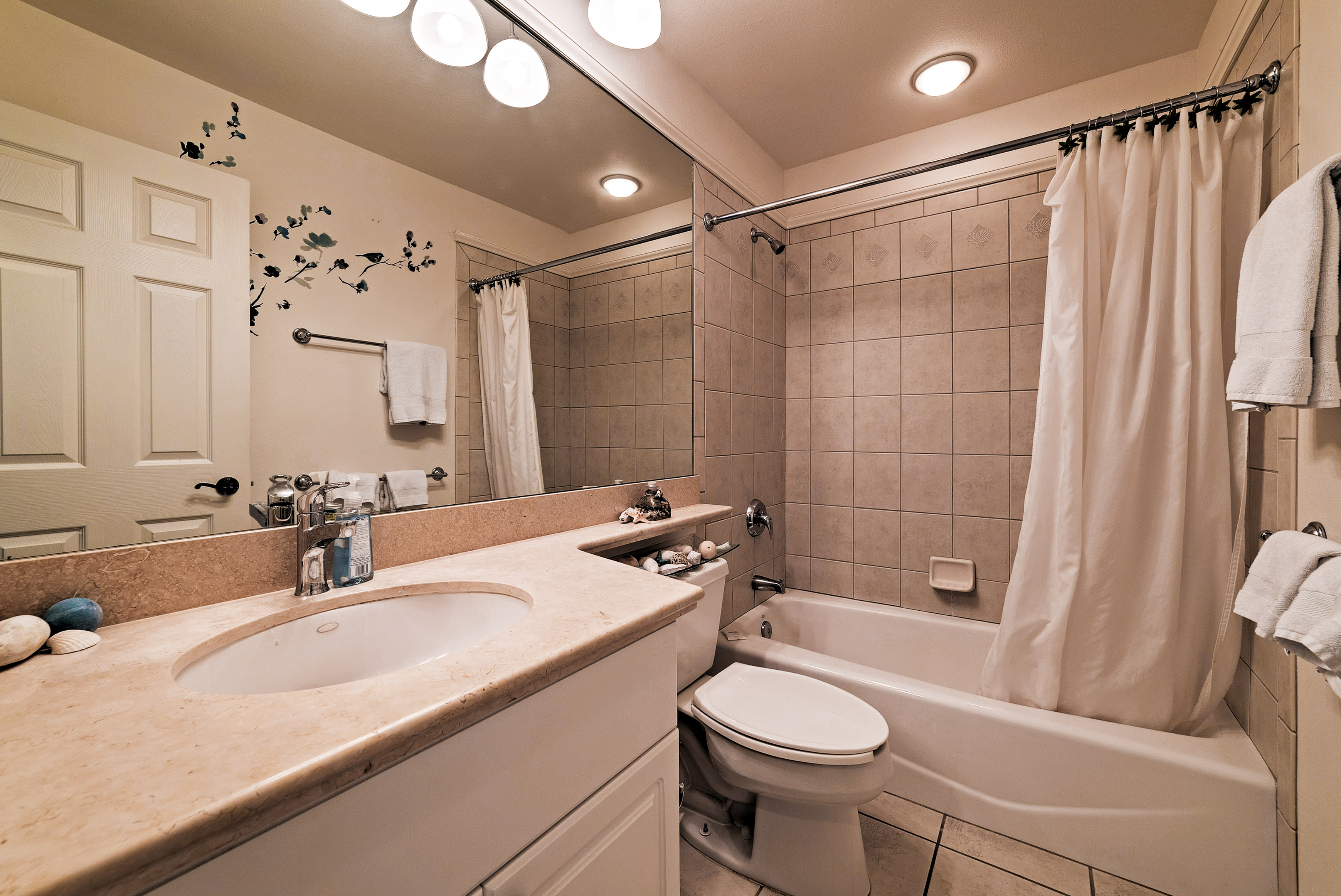 Take a shower or bath in this full bathroom.