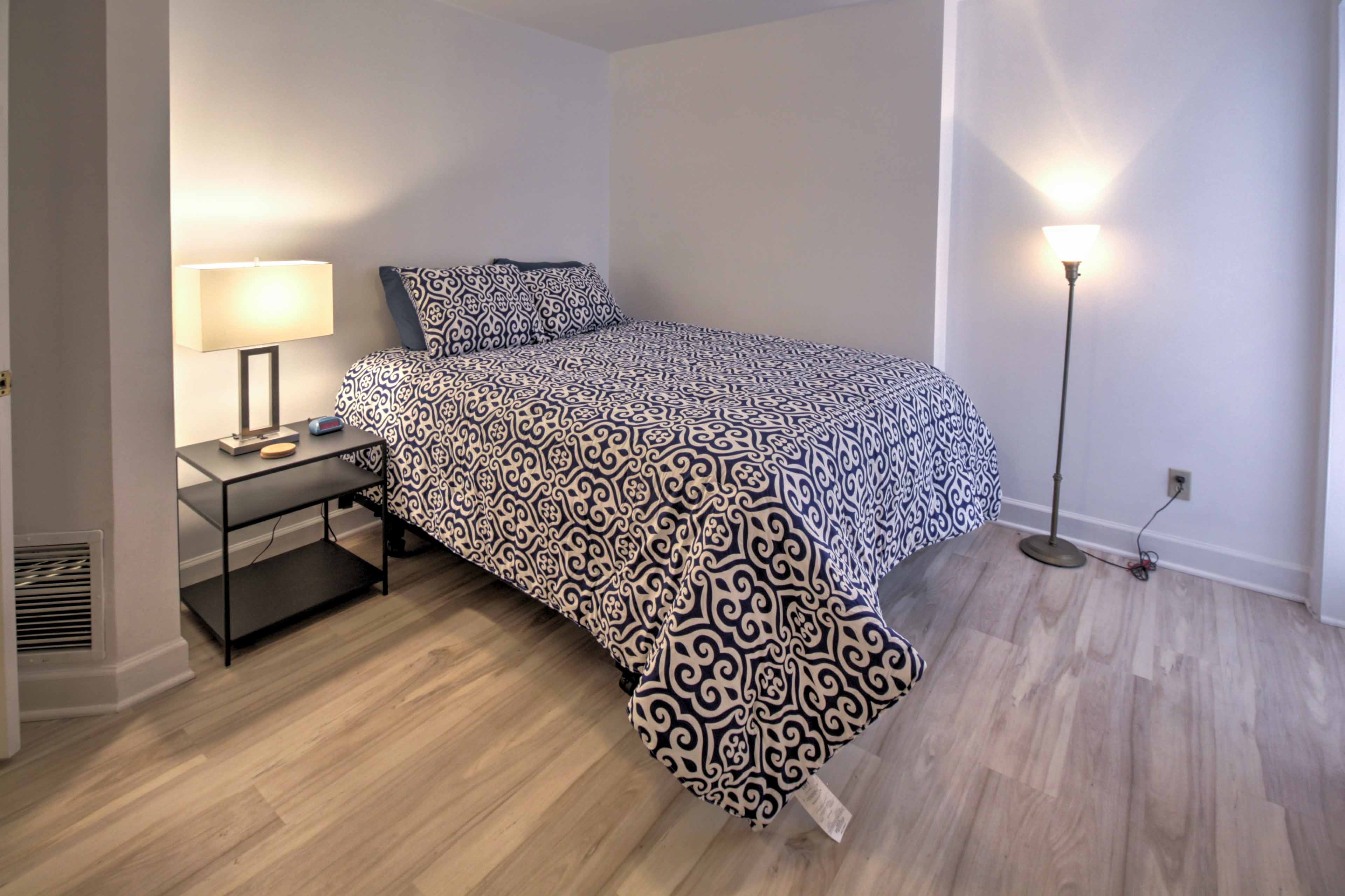 The master bedroom hosts a queen bed.