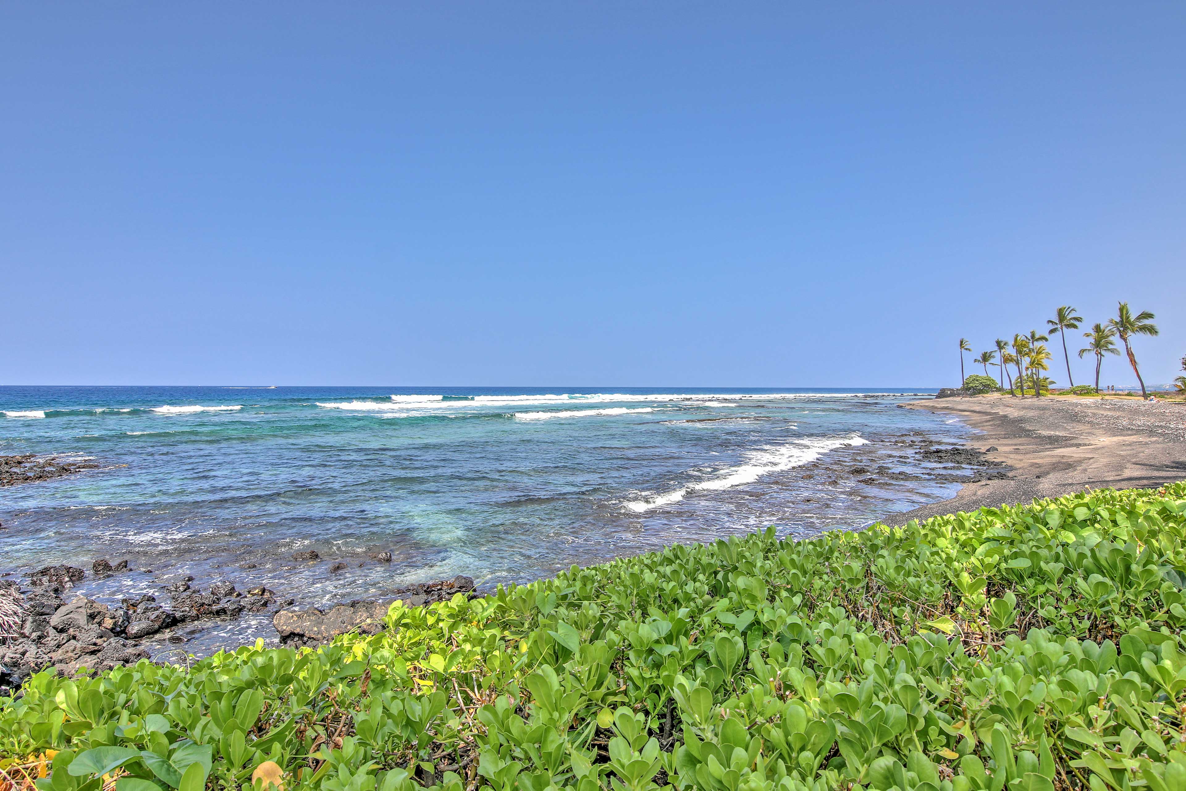 Walk to the beach when you stay at this Kailua Kona vacation rental town home.