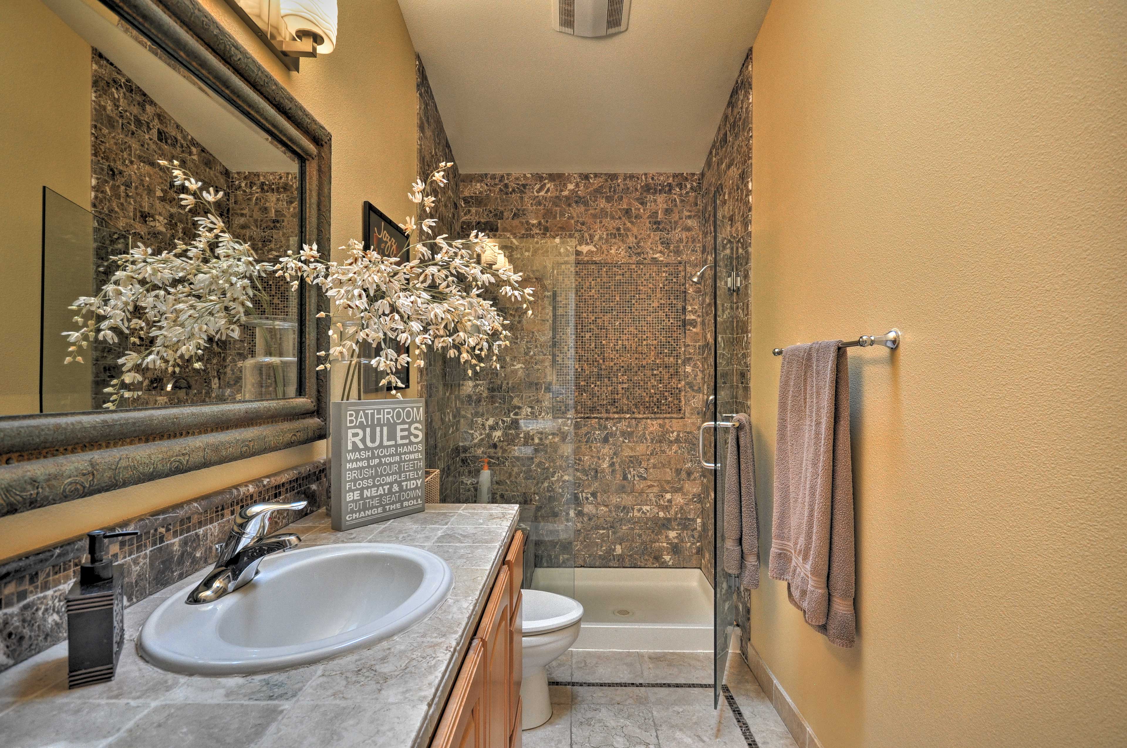 Wash off from a day at the beach in this beautifully styled bathroom.