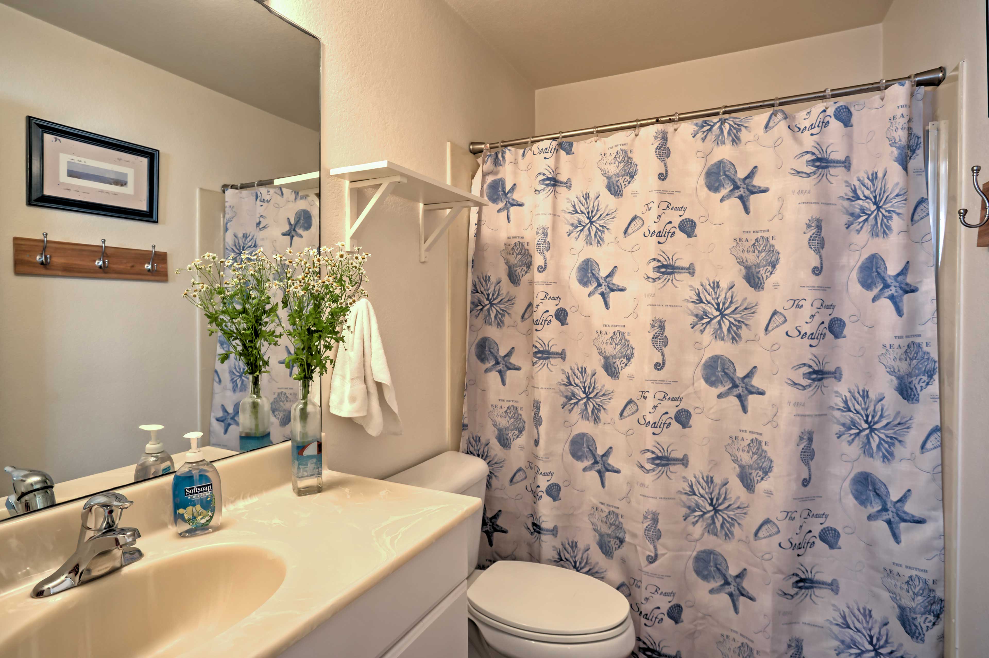 This bathroom features a shower/tub and single vanity.