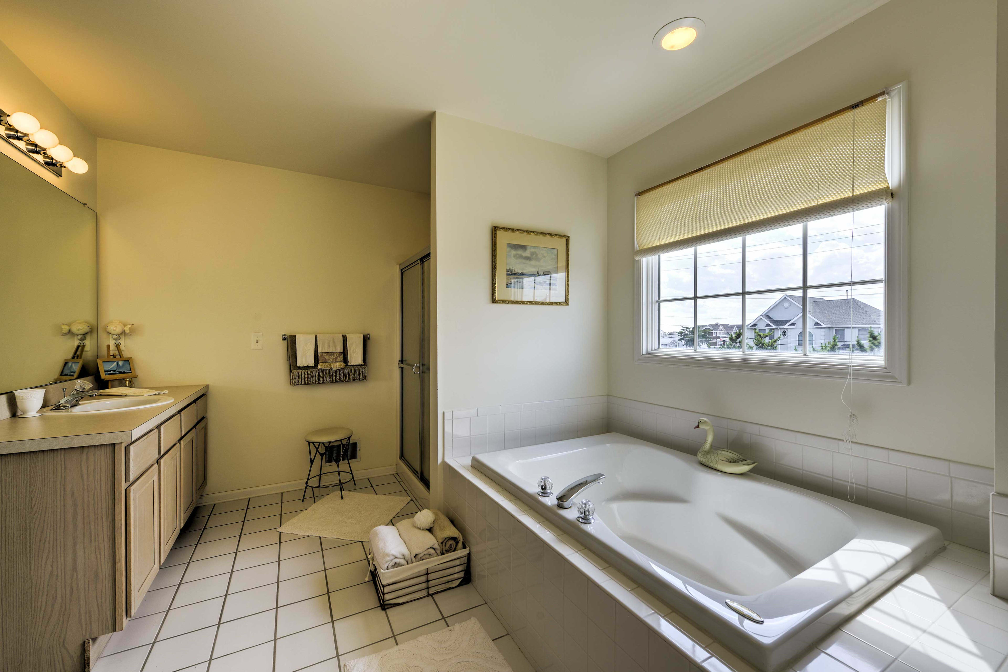 An en-suite bathroom features an oversized Jacuzzi tub.