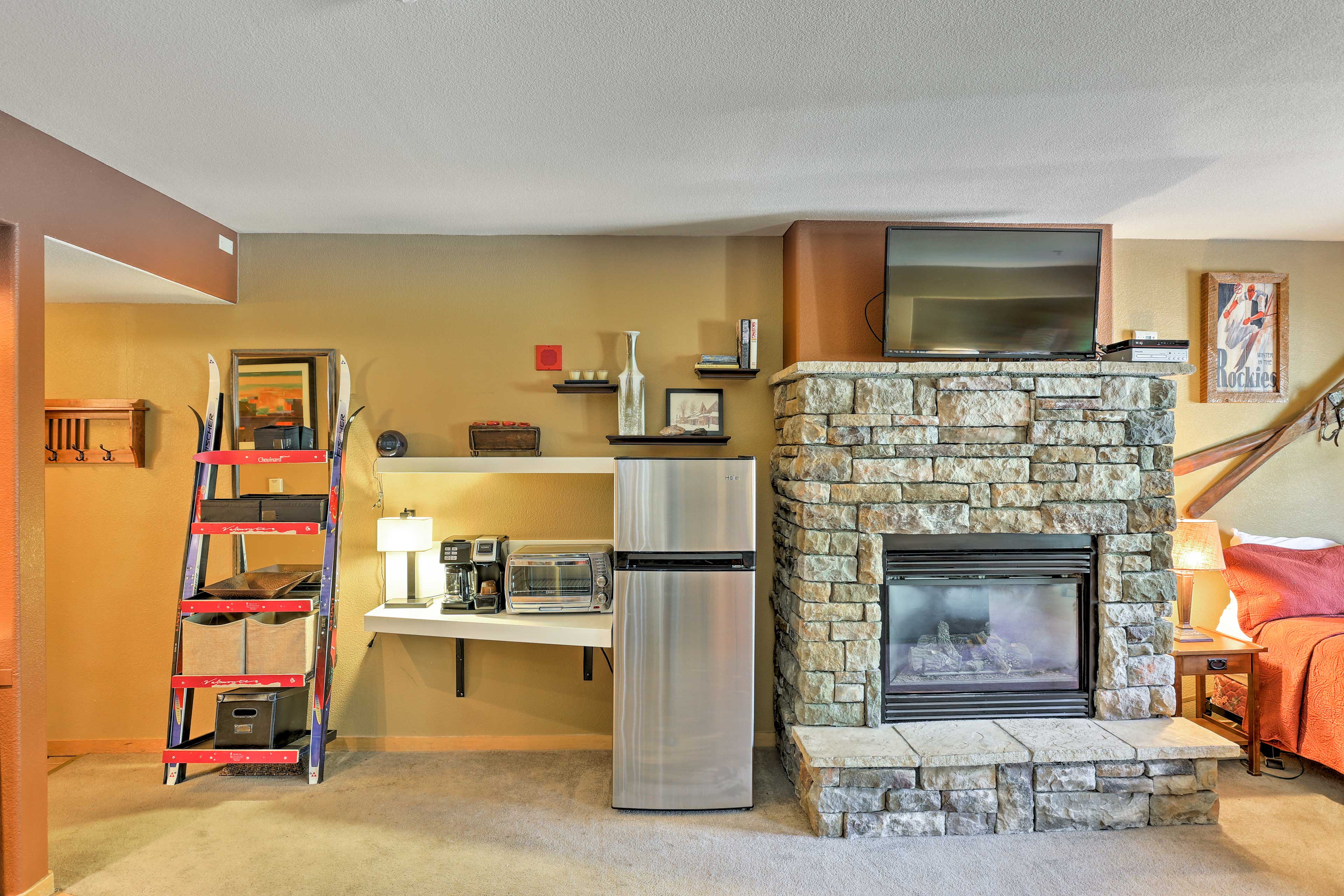 The stone gas fireplace serves as the centerpiece of the studio.