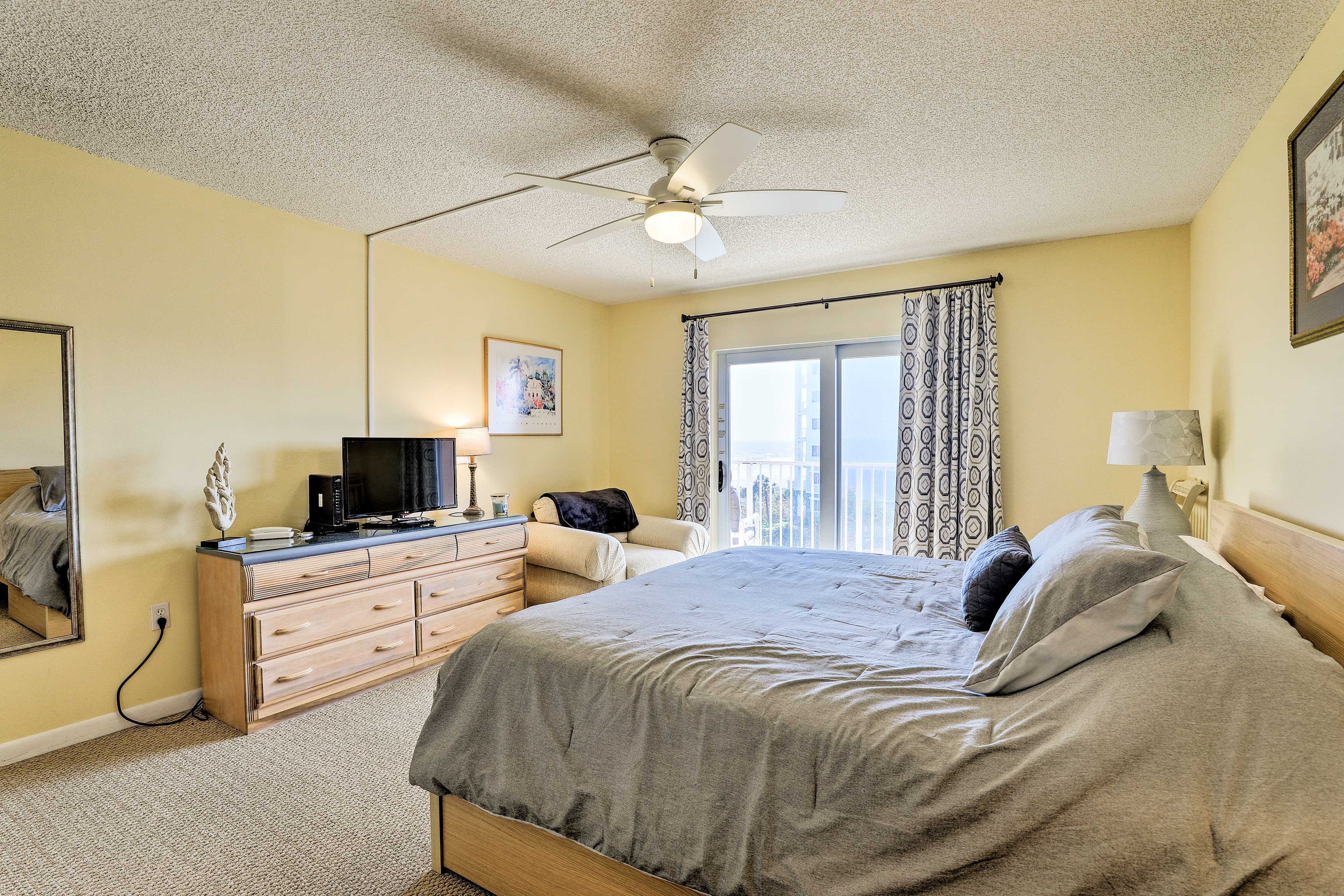 The main bedroom boasts a queen bed, a flat screen TV.