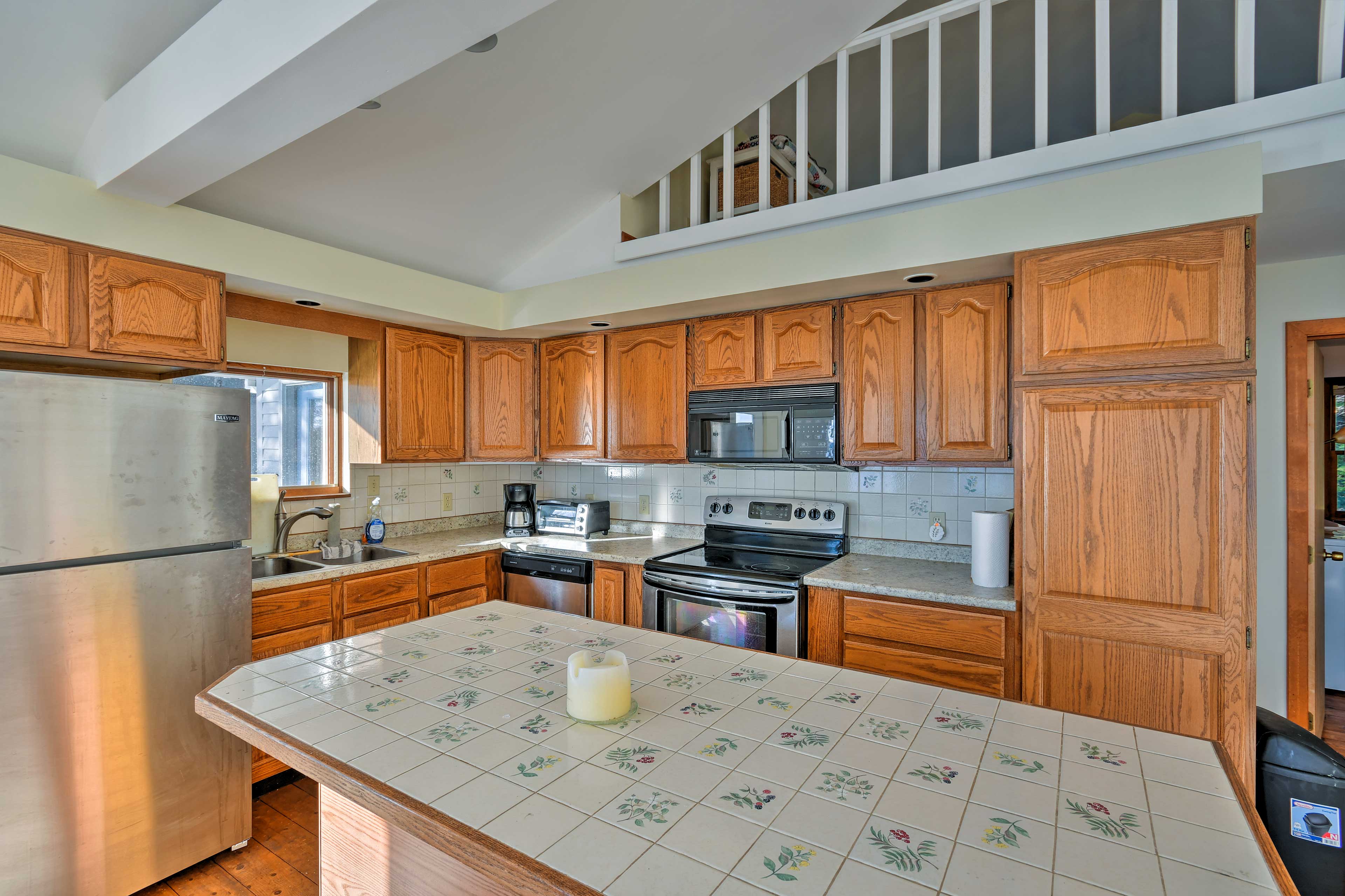 The kitchen is fully equipped with updated appliances and a kitchen island.