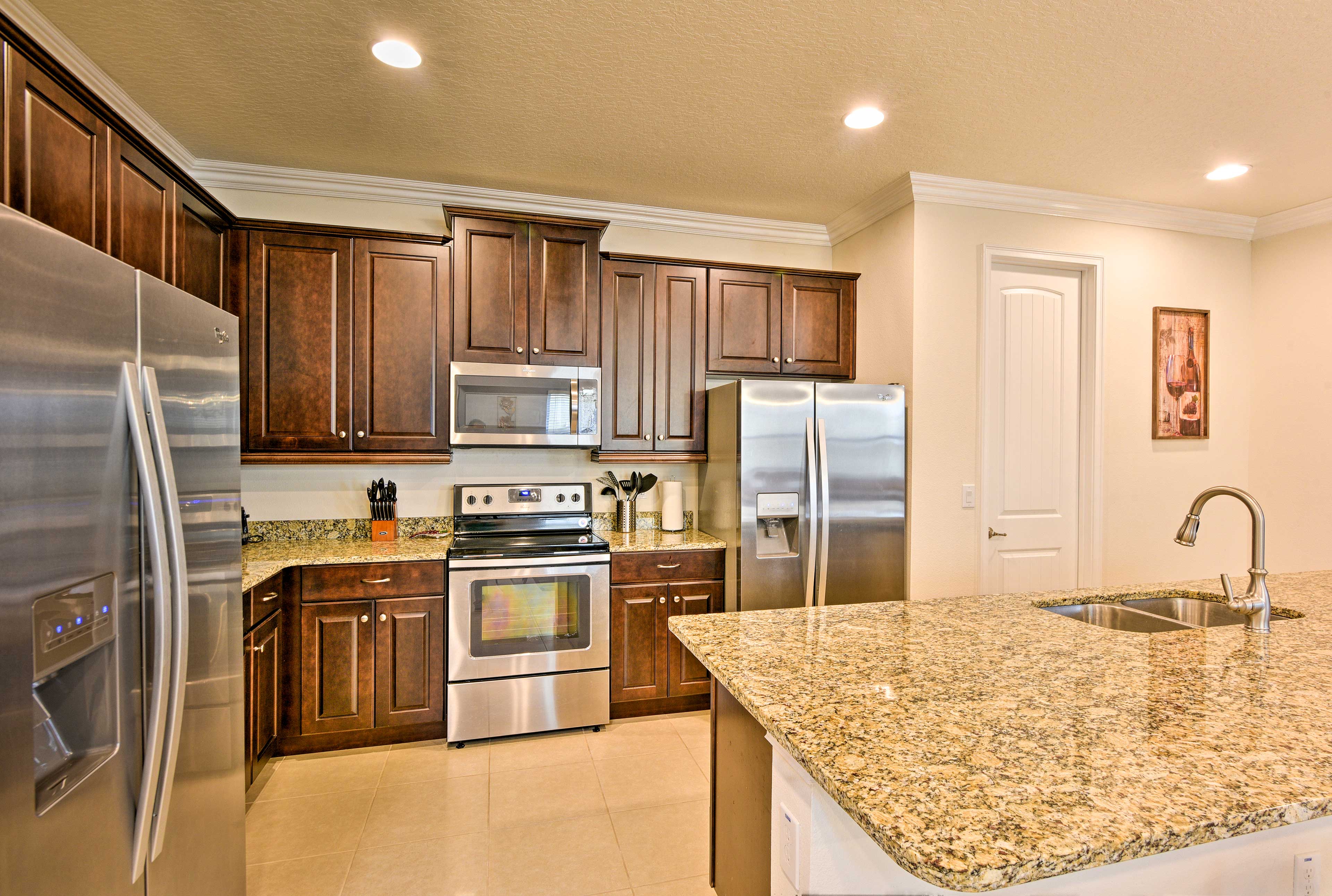 The fully equipped kitchen has stainless steel appliances and granite counters.