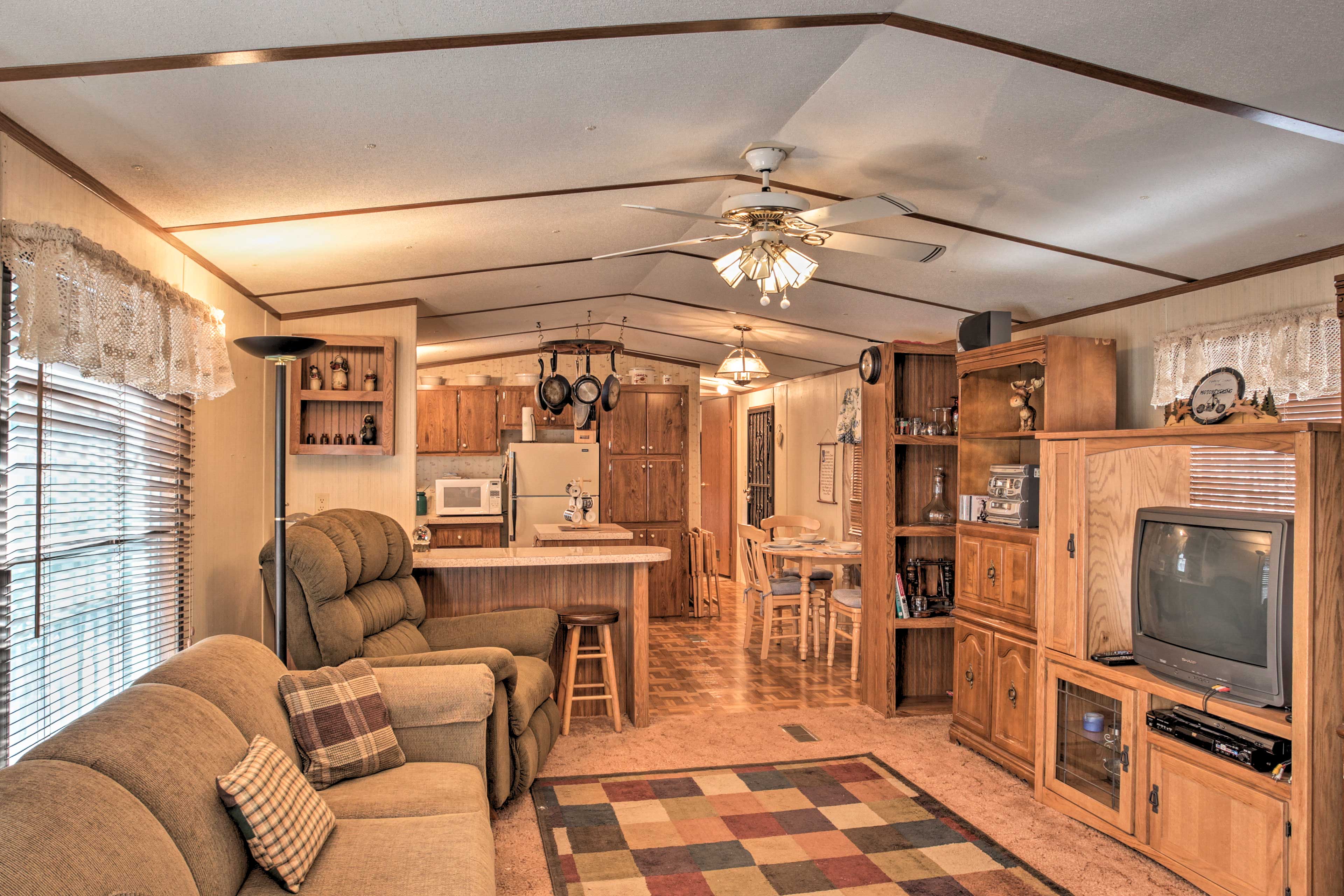 The cozy trailer cabin features comfortable furnishings and rustic decor.